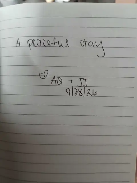 Handwritten note from a guest journal: A peaceful stay ∞ AQ + JJ 9/28/26