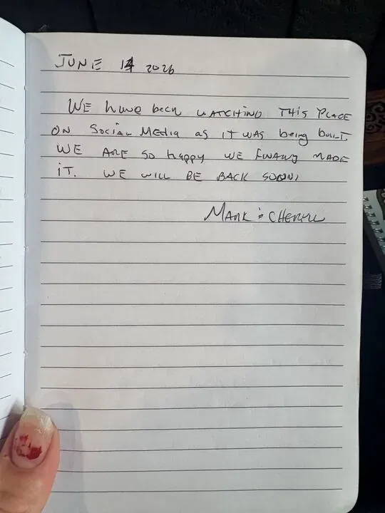 Handwritten guest journal page: JUNE 14 2026 WE HAVE BEEN WATCHING THIS PLACE ON SOCIAL MEDIA AS IT WAS BEING BUILT. WE ARE SO HAPPY