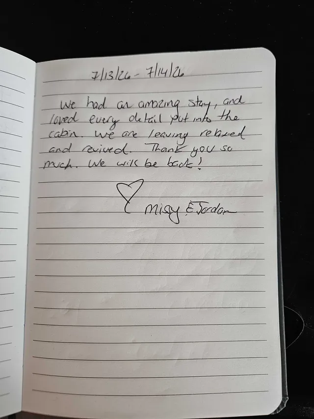 Handwritten guest journal page: 7/13/26 - 7/14/26 We had an amazing stay, and loved every detail put into the cabin. We are leaving 