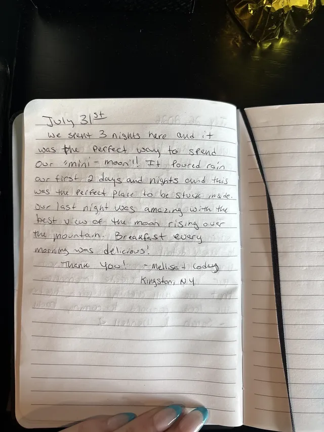 Handwritten guest journal page: July 31st we spent 3 nights here and it was the perfect way to spend our "mini-moon"! It poured rain