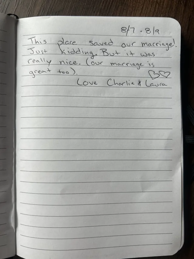 Handwritten guest journal page: 8/7 - 8/9 This place saved our marriage! Just kidding. But it was really nice. (our marriage is grea