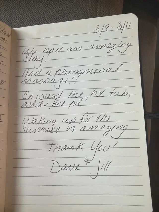 Handwritten guest journal page: 8/9-8/11 We had an amazing stay! Had a phenomenal massage!! Enjoyed the hot tub, and fire pit. Wakin
