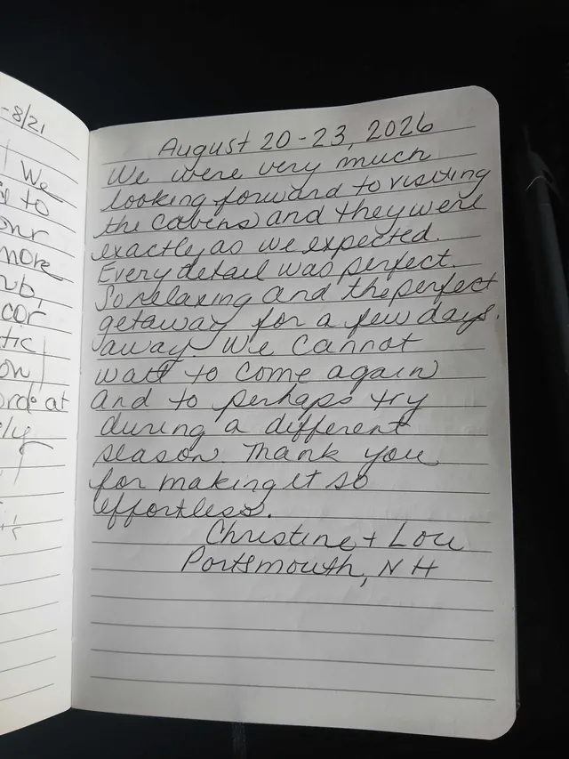 Handwritten guest journal page: August 20-23, 2026 We were very much looking forward to visiting the cabins and they were exactly as