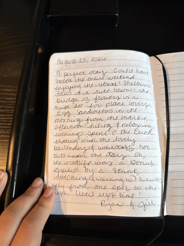 Handwritten guest journal page: August 23, 2026 A perfect stay. Could have spent the entire weekend enjoying the retreat! Shelburne 
