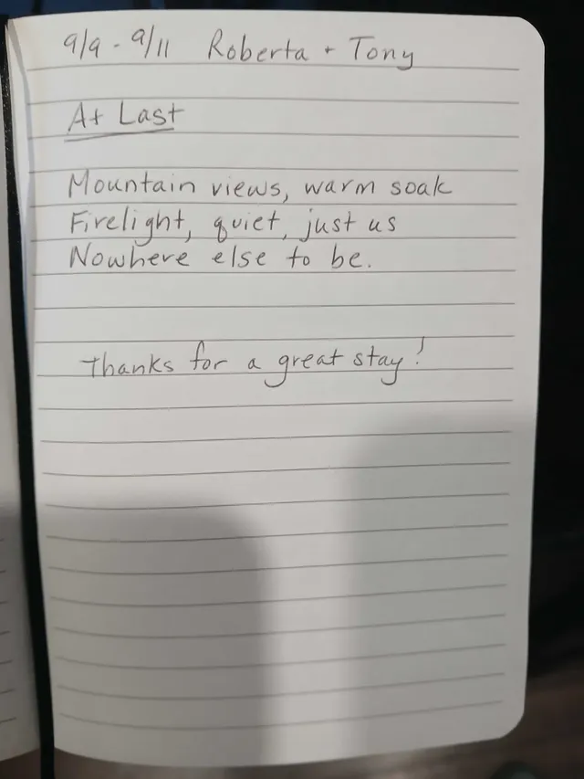 Handwritten guest journal page: 9/9 - 9/11 Roberta + Tony At Last Mountain views, warm soak Firelight, quiet, just us Nowhere else t