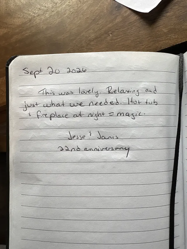 Handwritten guest journal page: Sept 20 2026 This was lovely. Relaxing and just what we needed. Hot tub & fireplace at night = magic
