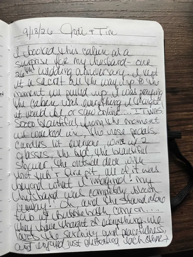 Handwritten guest journal page: 9/18/26 - Jodi & Tim I booked this cabin as a surprise for my husband - our 26th wedding anniversary