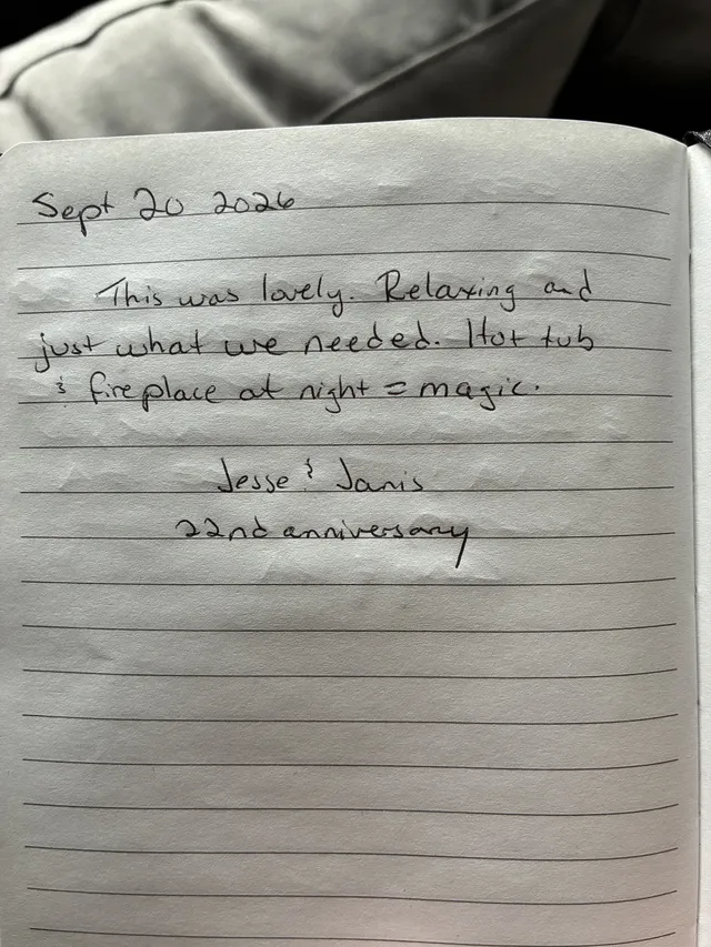 Handwritten guest journal page: Sept 20 2026 This was lovely. Relaxing and just what we needed. Hot tub & fireplace at night = magic