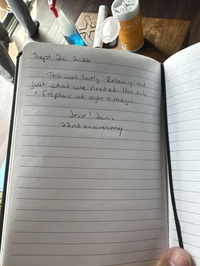 Handwritten guest journal page: Sept 20 2026 This was lovely. Relaxing and just what we needed. Hot tub & fireplace at night = magic