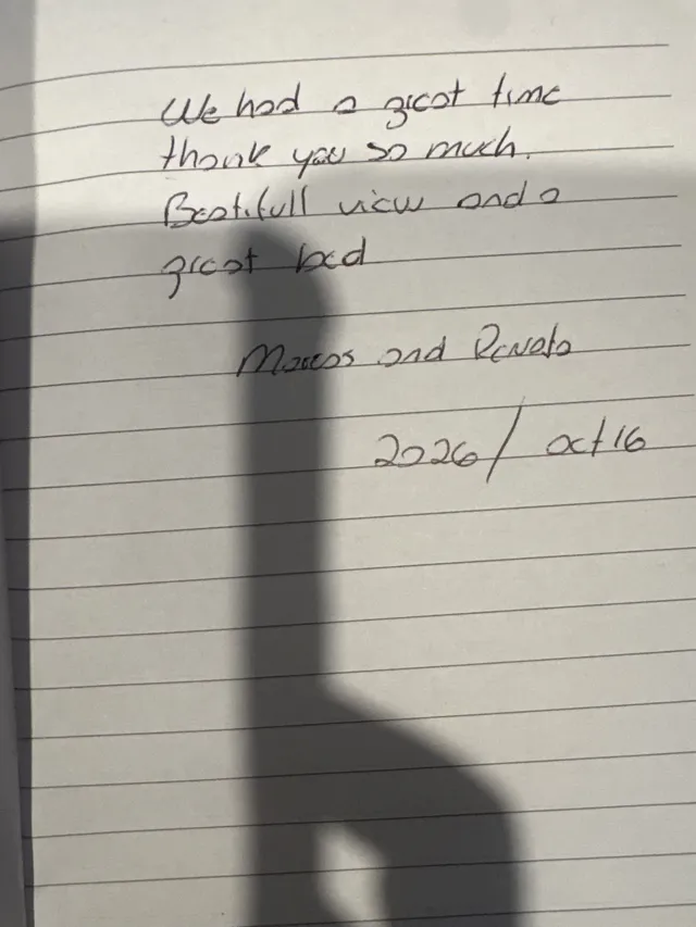 Handwritten guest journal page: We had a great time thank you so much. Beautiful view and a great bed. Marcos and Renela 2026 / oct 
