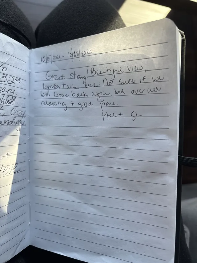 Handwritten guest journal page: 10/15/2026 - 10/18/2026 Great stay! Beautiful view, comfortable bed. Not sure if we will come back a