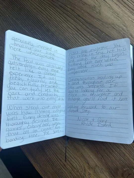 Handwritten guest journal page: genuinely invested in making our time here unforgettable. The food was absolutely outstanding - ever
