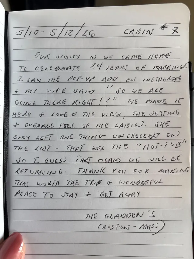 Handwritten guest journal page: 5/10 - 5/12/26 CABIN # 7 OUR STORY IS WE CAME HERE TO CELEBRATE 24 YEARS OF MARRIAGE I SAW THE POP-U