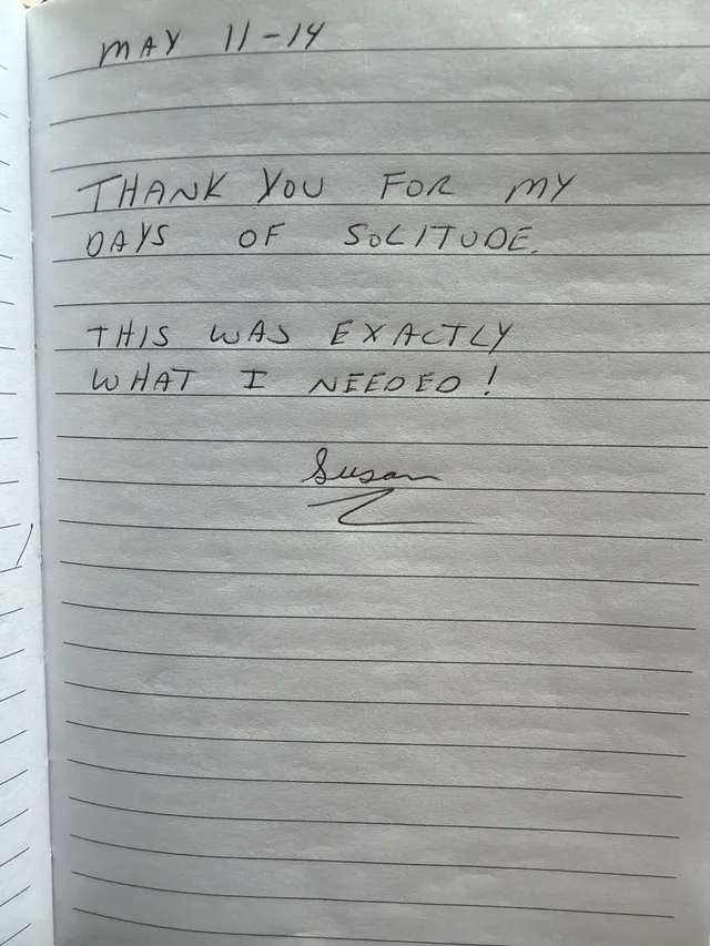 Handwritten guest journal page: MAY 11-14 THANK YOU FOR MY DAYS OF SOLITUDE. THIS WAS EXACTLY WHAT I NEEDED! Susan
